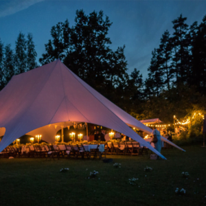 A star marquee tent set up on a school or college campus for a special event.