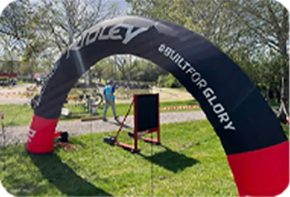 Large archway with brand logo or sponsor ads as the event entrance.
